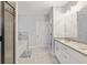 Modern bathroom featuring a soaking tub and double vanity with granite countertops and soft gray flooring at 8050 Tristan Way, Whitesburg, GA 30185