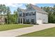 Stylish home with a long driveway, and an attached two-car garage surrounded by a lush green lawn at 8050 Tristan Way, Whitesburg, GA 30185