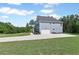 Side view of a well-maintained home with an attached two-car garage and a long, paved driveway at 8050 Tristan Way, Whitesburg, GA 30185