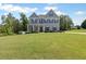 Charming two-story home featuring a well-manicured lawn and inviting curb appeal with a covered front porch at 8050 Tristan Way, Whitesburg, GA 30185