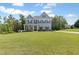 Charming two-story home featuring a well-manicured lawn and inviting curb appeal with a covered front porch at 8050 Tristan Way, Whitesburg, GA 30185