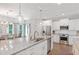 Island kitchen with granite countertops, stainless steel appliances, and pendant lights at 8050 Tristan Way, Whitesburg, GA 30185