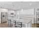Island kitchen with white cabinets, granite countertops and stainless steel appliances at 8050 Tristan Way, Whitesburg, GA 30185