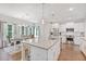 Open-concept kitchen with an island, dining table, and stainless steel appliances at 8050 Tristan Way, Whitesburg, GA 30185