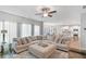 Spacious living room with a large sectional sofa, open to the kitchen and dining area for seamless living at 8050 Tristan Way, Whitesburg, GA 30185