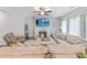 Spacious living room featuring a fireplace, large sectional sofa, and recessed lighting at 8050 Tristan Way, Whitesburg, GA 30185