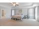 Spacious main bedroom featuring tray ceilings, neutral carpet, and a spa-like ensuite bathroom at 8050 Tristan Way, Whitesburg, GA 30185