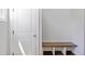 Mud room with a wood bench and storage under, next to a white door at 8050 Tristan Way, Whitesburg, GA 30185
