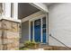 Close-up of a home's entryway, highlighting the blue front door, stone columns and charming details at 1007 Blue Ridge Ne Ave, Atlanta, GA 30306