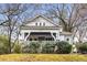 Charming bungalow with a welcoming front porch, stone accents, and mature trees enhancing the curb appeal at 1007 Blue Ridge Ne Ave, Atlanta, GA 30306