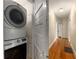 Hallway with hardwood floors and stacked washer and dryer at 1007 Blue Ridge Ne Ave, Atlanta, GA 30306