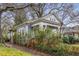Side exterior view of a home with a cozy porch, showcasing its architecture and surrounding greenery at 1007 Blue Ridge Ne Ave, Atlanta, GA 30306