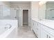 Luxury bathroom includes a soaking tub, glass-enclosed shower, and dual vanities at 516 Healy Dr # 69, Cumming, GA 30040