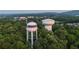 Aerial view of the community water towers located among mature trees and landscaping at 516 Healy Dr # 69, Cumming, GA 30040