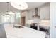 Bright kitchen featuring stainless steel appliances, white cabinets, and a large center island with pendant lighting at 516 Healy Dr # 69, Cumming, GA 30040