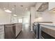 Modern kitchen with stainless steel appliances, light gray cabinets, and a view of the open living space at 516 Healy Dr # 69, Cumming, GA 30040