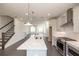 Open kitchen design with white countertops, stainless appliances, and an island overlooking the living area at 516 Healy Dr # 69, Cumming, GA 30040