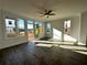 Sun-filled living room with wood flooring, windows, and a glass door leading to an outdoor deck at 516 Healy Dr # 69, Cumming, GA 30040