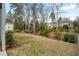Expansive backyard with lush lawn, mature trees, and neighborhood views at 662 Timm Valley Ne Rd, Atlanta, GA 30305