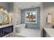 Bright bathroom featuring a modern tub, glass shower, blue accent tiles, and double vanity at 662 Timm Valley Ne Rd, Atlanta, GA 30305