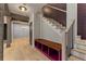 Inviting entryway with wooden beams, staircase, built-in bench, and hardwood floors at 662 Timm Valley Ne Rd, Atlanta, GA 30305