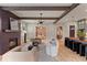 Open-concept living room features modern fireplace, wood beams, and seamless flow to kitchen area at 662 Timm Valley Ne Rd, Atlanta, GA 30305
