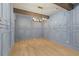 A living room features elegant wall paneling, hardwood flooring, and a modern chandelier at 662 Timm Valley Ne Rd, Atlanta, GA 30305
