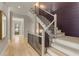 Elegant staircase with wooden steps, black metal railing, and natural light, leading to upper level at 662 Timm Valley Ne Rd, Atlanta, GA 30305