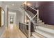 Elegant staircase with wood treads, black iron railing, and accent wall at 662 Timm Valley Ne Rd, Atlanta, GA 30305