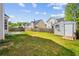 The spacious backyard has green grass, a storage shed, and a privacy fence at 1297 Quail Hunt Dr, Riverdale, GA 30296