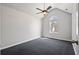 Cozy bedroom featuring textured ceiling, arched window, and neutral color scheme at 1297 Quail Hunt Dr, Riverdale, GA 30296