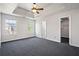Spacious bedroom with ceiling fan, large windows, and a convenient walk-in closet at 1297 Quail Hunt Dr, Riverdale, GA 30296