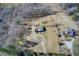 Expansive aerial view of a home with a circular driveway and green lawn at 1603 Drowning Creek Rd, Dacula, GA 30019
