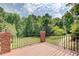 Inviting back deck space with wrought iron railing, offering peaceful views of the lush green backyard at 1603 Drowning Creek Rd, Dacula, GA 30019
