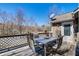 Back deck with a table and chairs, perfect for outdoor dining and relaxation at 1603 Drowning Creek Rd, Dacula, GA 30019