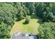 Secluded backyard features a level lawn and wooded perimeter, offering privacy and ample space for outdoor activities at 1603 Drowning Creek Rd, Dacula, GA 30019