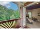 Balcony view into a sitting room with a fireplace, offering a serene retreat with views of the green landscape at 1603 Drowning Creek Rd, Dacula, GA 30019