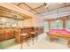 Entertainment area with a pool table and a bar featuring a sink and seating at 1603 Drowning Creek Rd, Dacula, GA 30019
