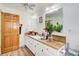 Bright bathroom featuring dual sinks, countertops, wood floors, and a door leading to other areas at 1603 Drowning Creek Rd, Dacula, GA 30019