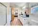 Bright bathroom with shower, vanity with double sinks, and wood-look floors at 1603 Drowning Creek Rd, Dacula, GA 30019