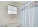 Bathroom featuring a shower with light blue decorative curtain and a window to allow for natural light at 1603 Drowning Creek Rd, Dacula, GA 30019