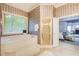 Large bathroom featuring a soaking tub, a glass-enclosed shower, and an open doorway to the bedroom at 1603 Drowning Creek Rd, Dacula, GA 30019
