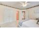 Inviting bedroom with soft carpet, a ceiling fan, and an ensuite bathroom at 1603 Drowning Creek Rd, Dacula, GA 30019