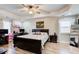 Spacious bedroom featuring a tray ceiling, wood flooring, and a charming study area at 1603 Drowning Creek Rd, Dacula, GA 30019