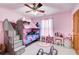 room features a pink color scheme, gray bunk beds with a small stair case and window with natural light at 1603 Drowning Creek Rd, Dacula, GA 30019