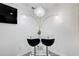 Modern dining area with glass table, stylish seating, and unique, decorative lighting at 1603 Drowning Creek Rd, Dacula, GA 30019