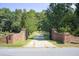 Gated entrance leads to a long driveway lined with trees at 1603 Drowning Creek Rd, Dacula, GA 30019