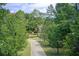 Long driveway leading to a charming home surrounded by lush greenery at 1603 Drowning Creek Rd, Dacula, GA 30019