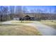 Charming home with a circular driveway and a well-manicured front yard at 1603 Drowning Creek Rd, Dacula, GA 30019