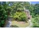 Two-story brick home featuring a deck and lush landscaping in a serene setting at 1603 Drowning Creek Rd, Dacula, GA 30019